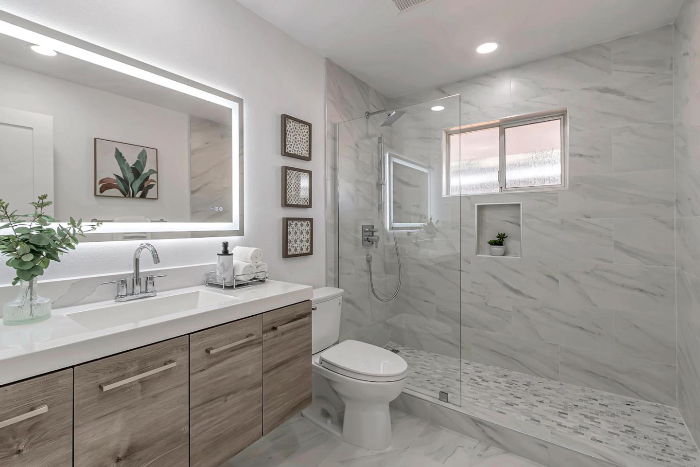 6722 Bollinger Road San Jose, CA 95129 - Photo 24 of 33 a bathroom with a toilet a sink a glass door a shower a mirror and vanity