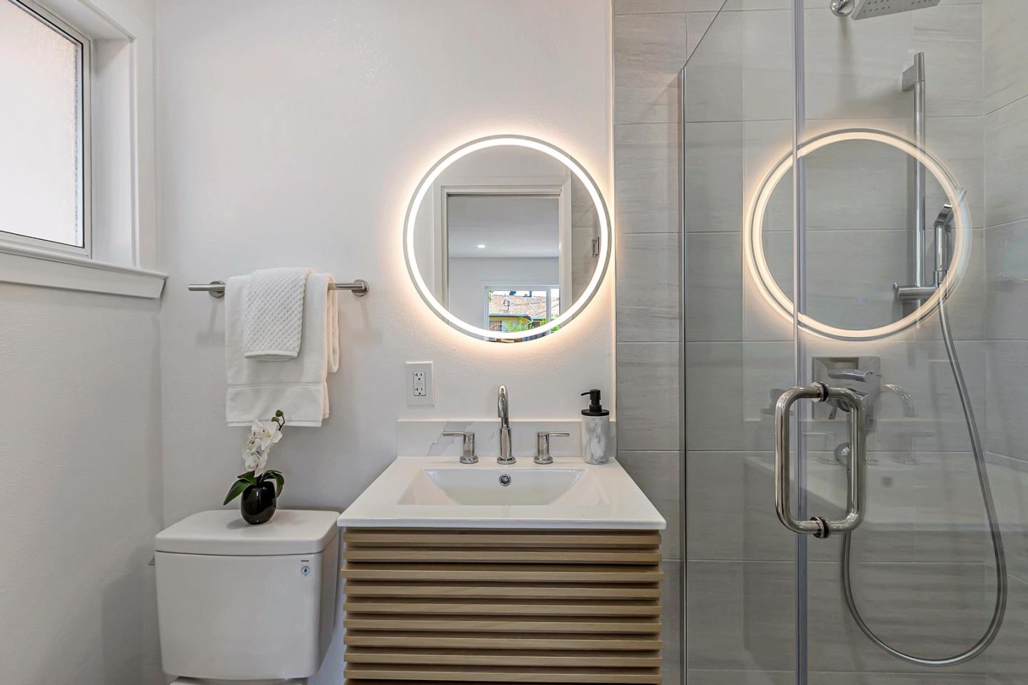 6722 Bollinger Road San Jose, CA 95129 - Photo 26 of 33 a bathroom with a sink a toilet and a mirror