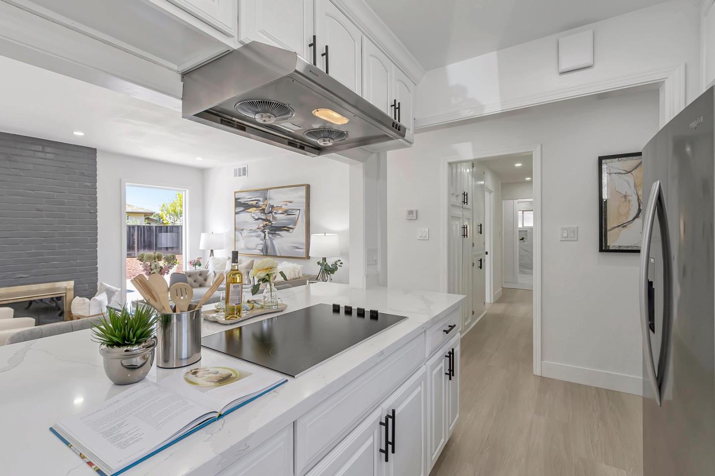 6722 Bollinger Road San Jose, CA 95129 - Photo 9 of 33 a kitchen with stainless steel appliances a sink a faucet cabinets and wooden floor