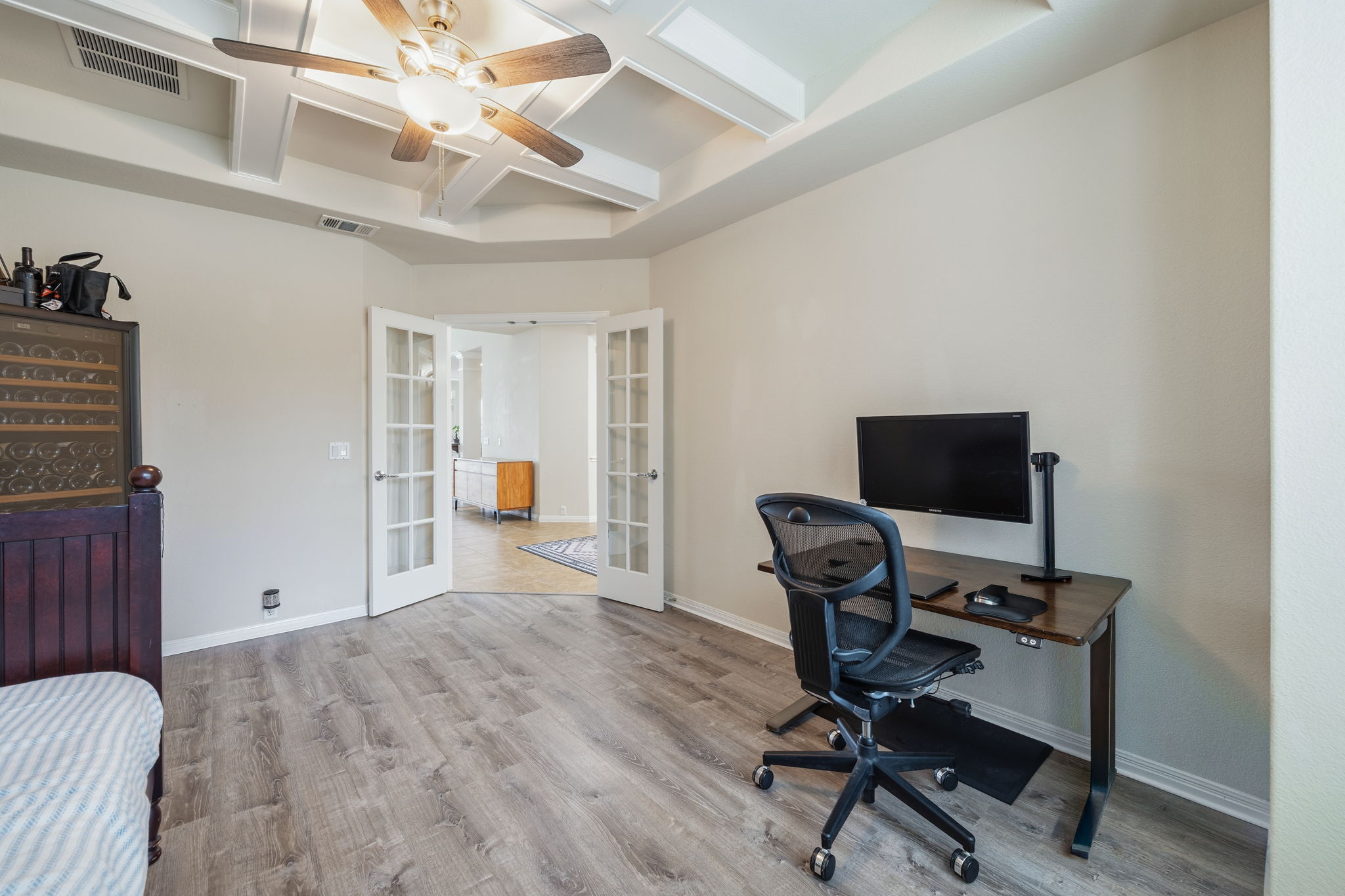 1581 Grassy Field Road Austin, TX 78737 - Photo 16 of 37 Double French doors open into a versatile space featuring detailed coffered ceilings and durable wood floors.