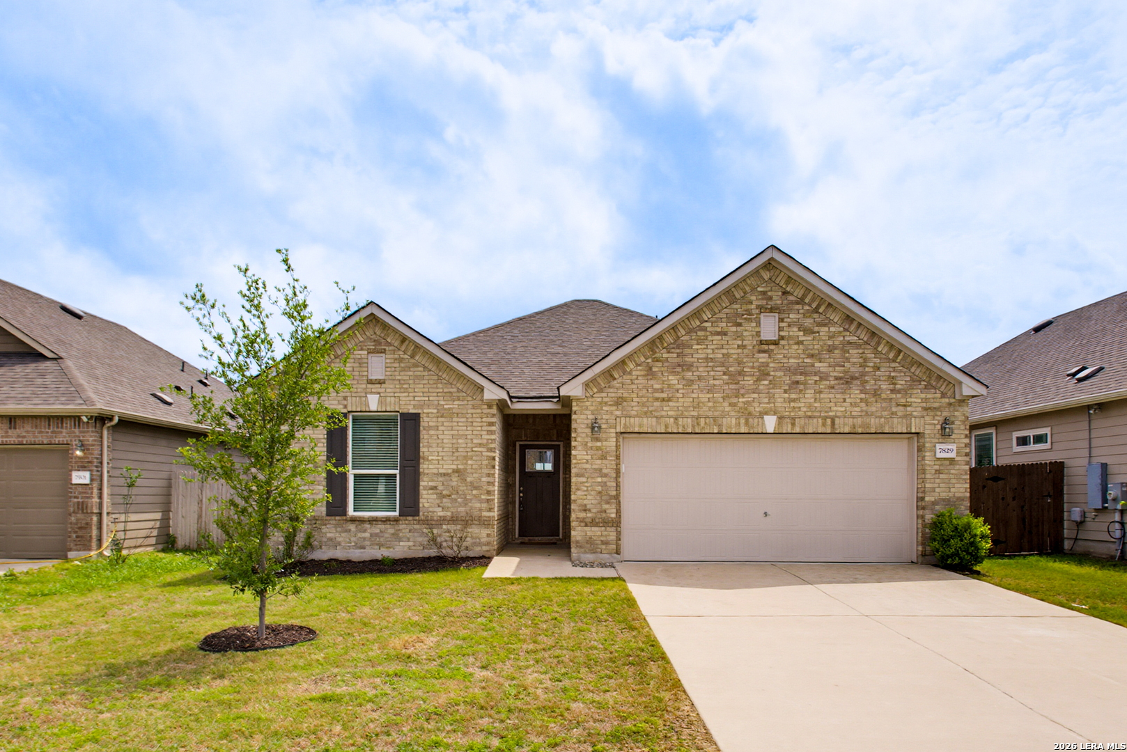 7829 Big Wind Way Austin, TX 78724 - Photo 1 of 26 a front view of a house with a garden and yard