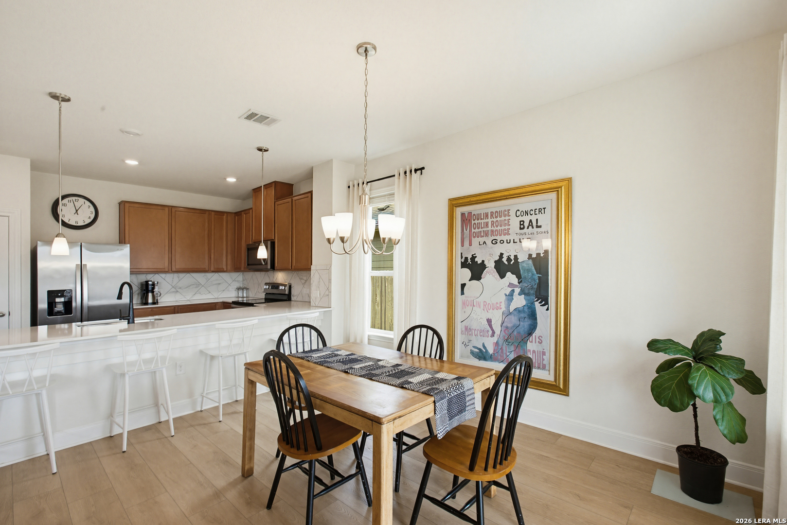 7829 Big Wind Way Austin, TX 78724 - Photo 11 of 26 a view of a dining room with furniture window and wooden floor
