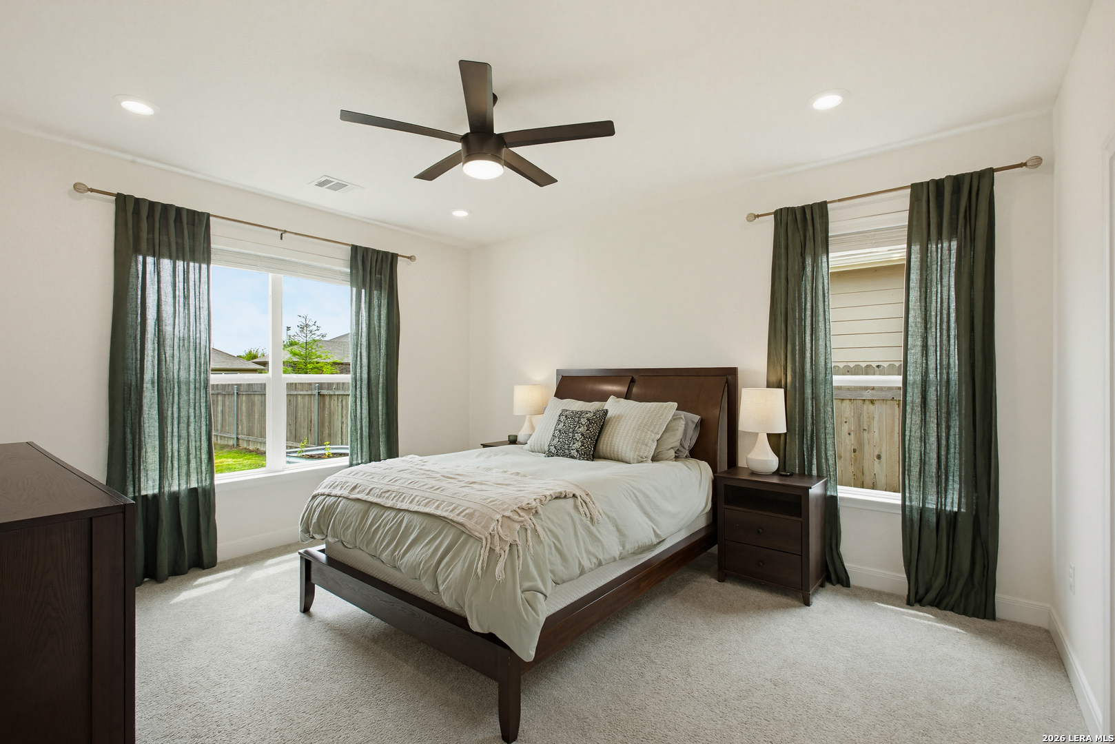 7829 Big Wind Way Austin, TX 78724 - Photo 13 of 26 a bedroom with a large bed and a large window