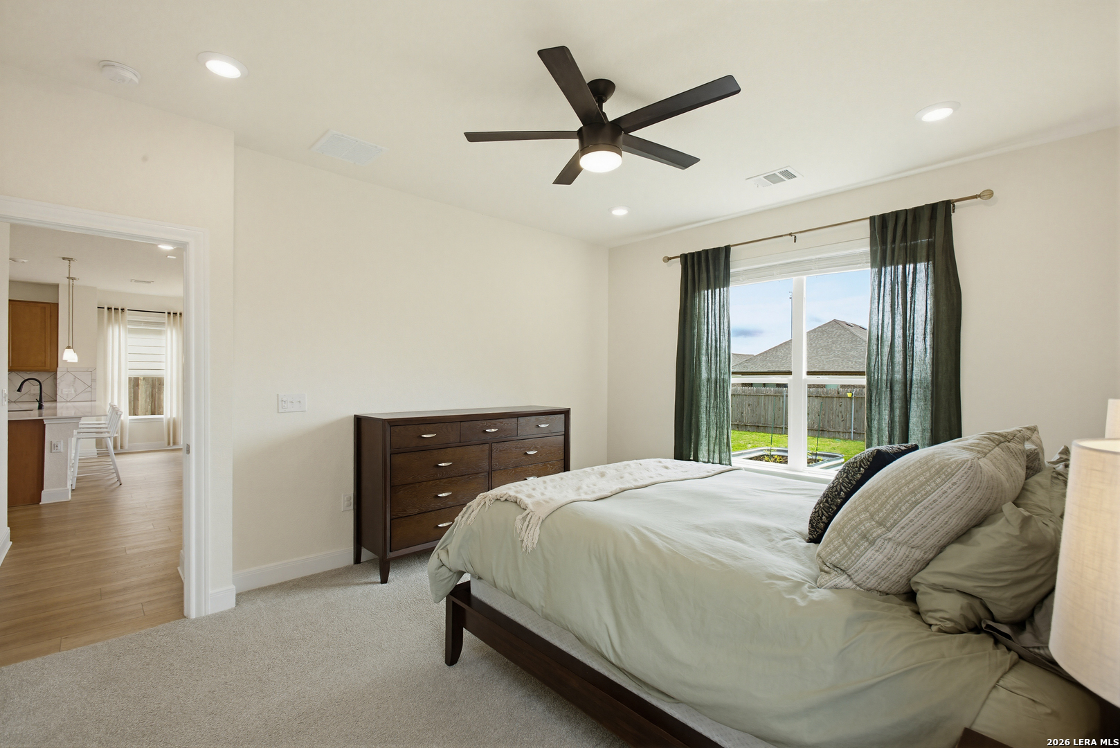 7829 Big Wind Way Austin, TX 78724 - Photo 14 of 26 a bedroom with a large bed and a large window