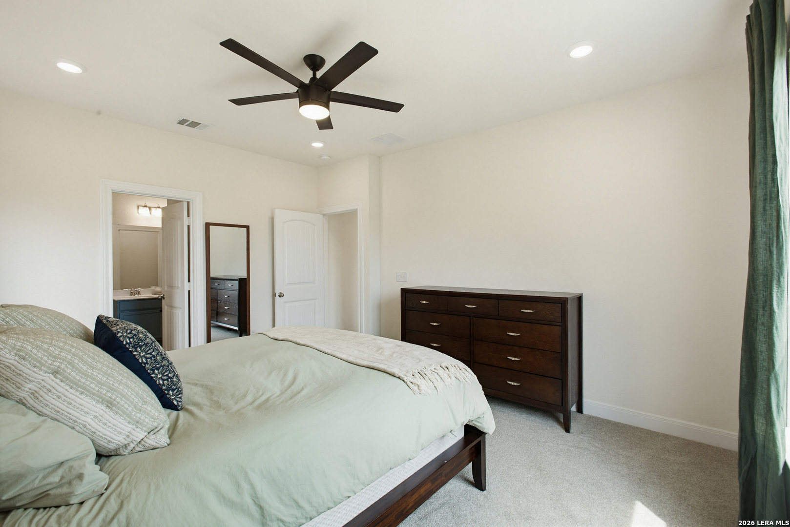 7829 Big Wind Way Austin, TX 78724 - Photo 15 of 26 a bedroom with a bed and ceiling fan