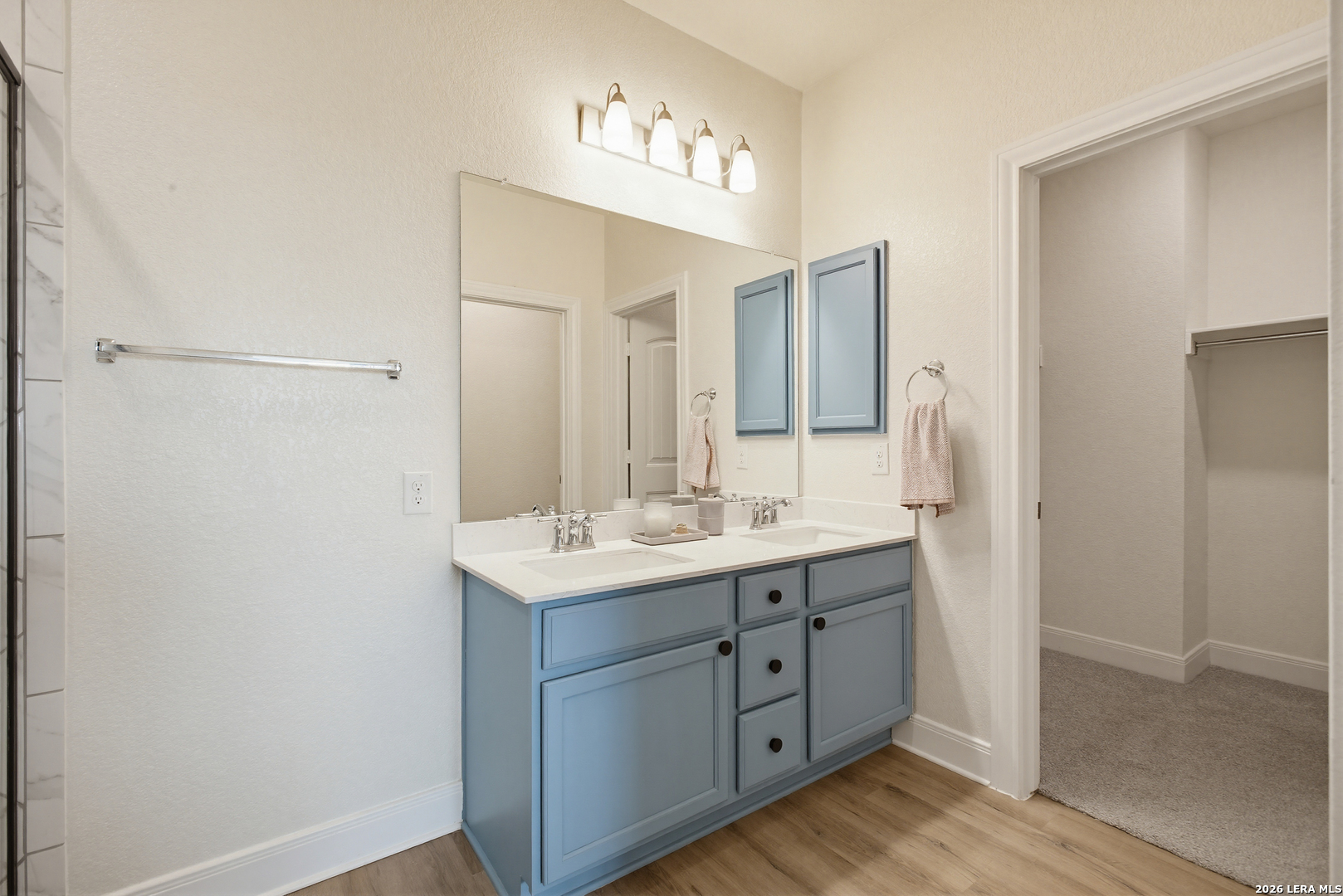 7829 Big Wind Way Austin, TX 78724 - Photo 16 of 26 a bathroom with a double vanity sink and a mirror