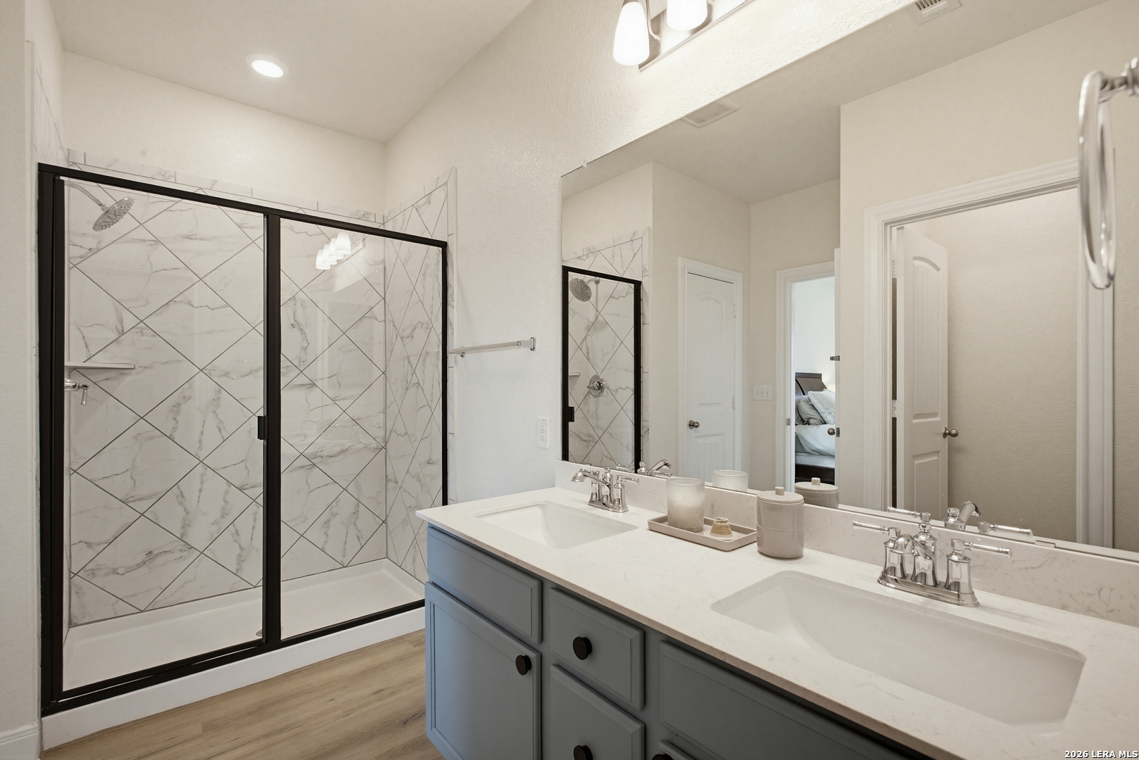 7829 Big Wind Way Austin, TX 78724 - Photo 17 of 26 a bathroom with a double vanity sink and mirror