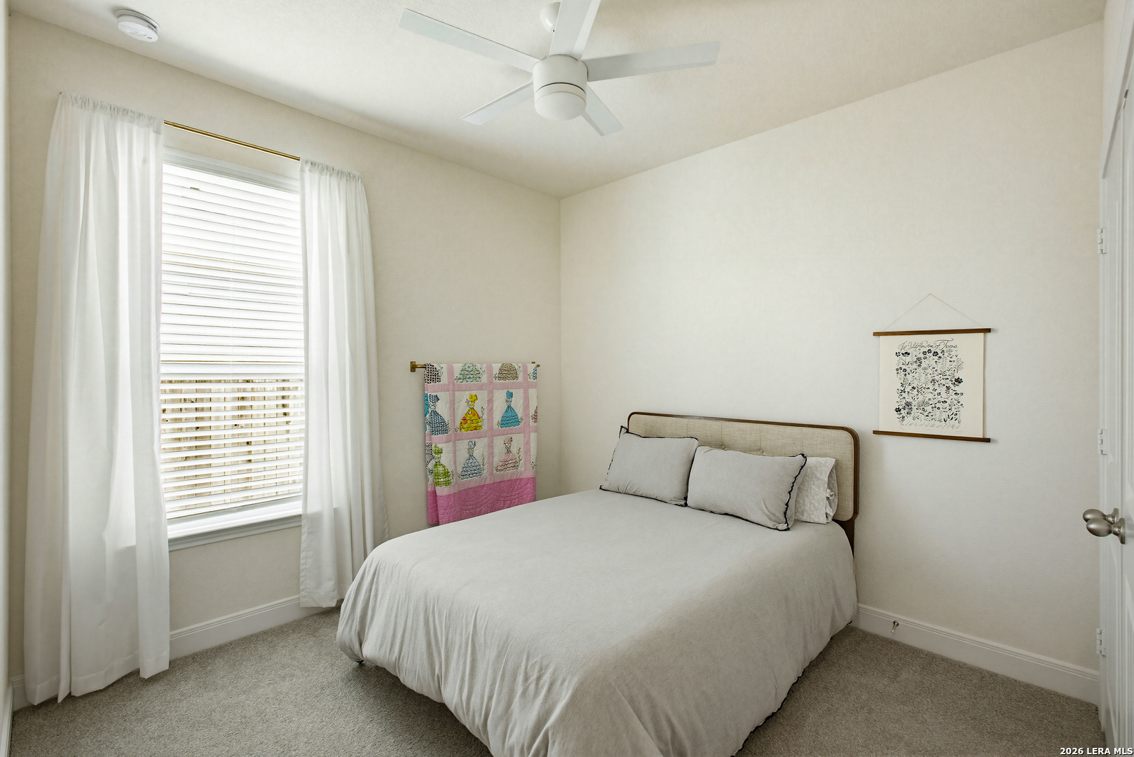 7829 Big Wind Way Austin, TX 78724 - Photo 18 of 26 a bedroom with a bed and a window