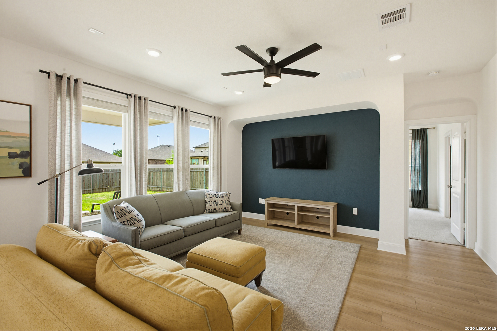 7829 Big Wind Way Austin, TX 78724 - Photo 5 of 26 a living room with furniture and a flat screen tv
