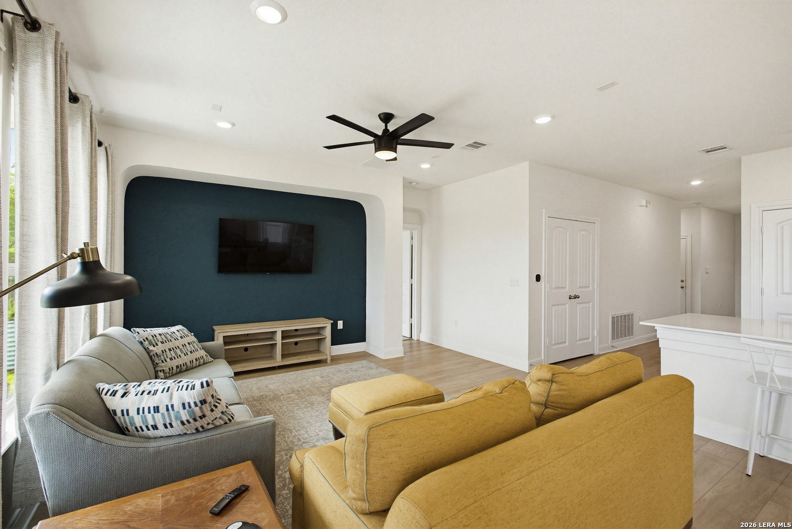 7829 Big Wind Way Austin, TX 78724 - Photo 6 of 26 a living room with furniture and a flat screen tv