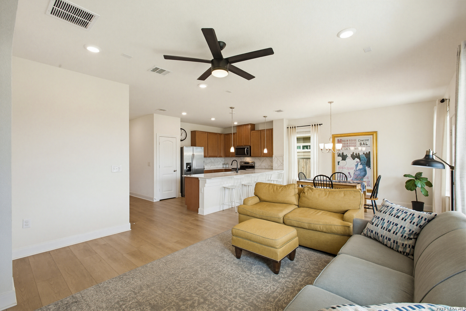7829 Big Wind Way Austin, TX 78724 - Photo 7 of 26 a living room with furniture and kitchen view