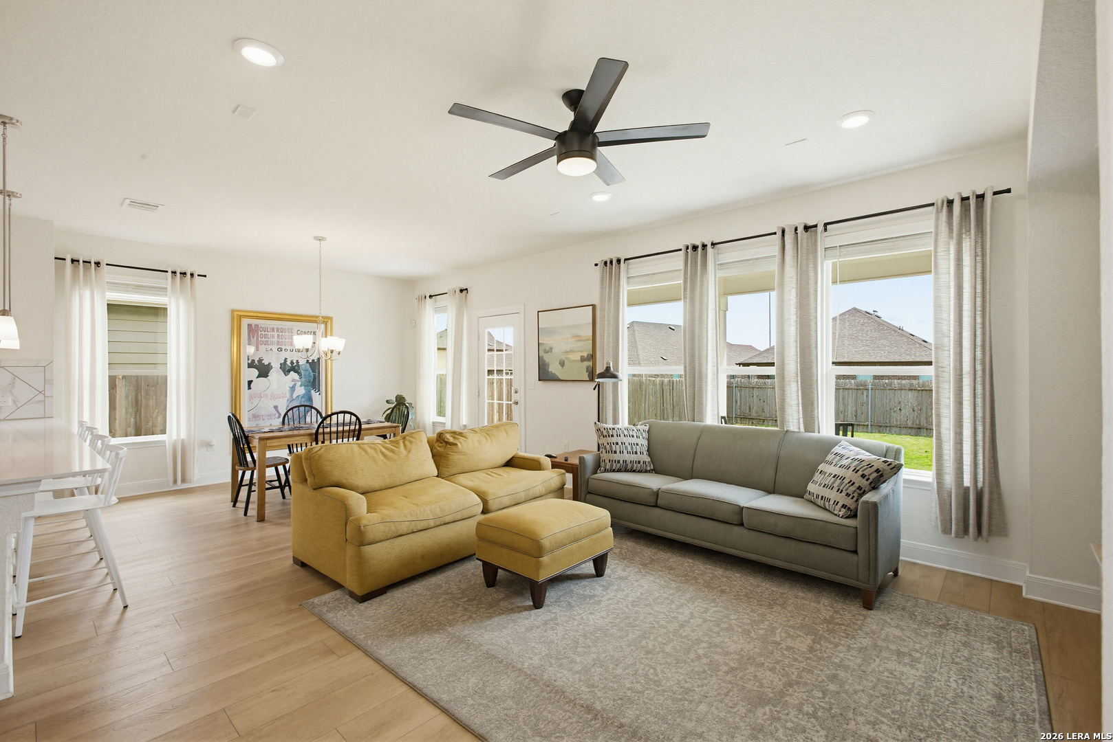 7829 Big Wind Way Austin, TX 78724 - Photo 8 of 26 a living room with furniture and a large window with wooden floor