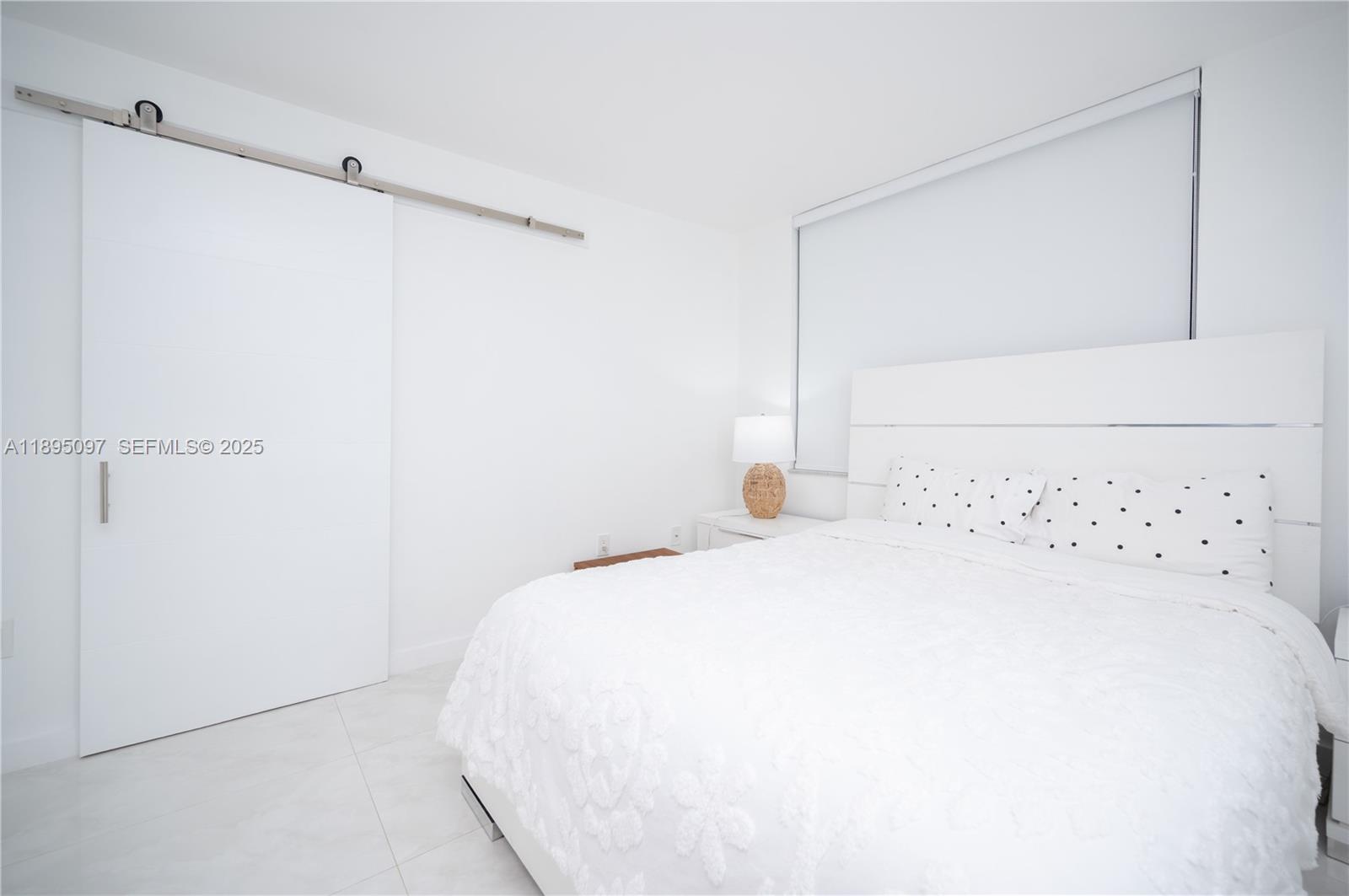 10875 Southwest 112th Avenue, Unit 204 Miami, FL 33176 - Photo 13 of 27 a bedroom with a bed and a mirror