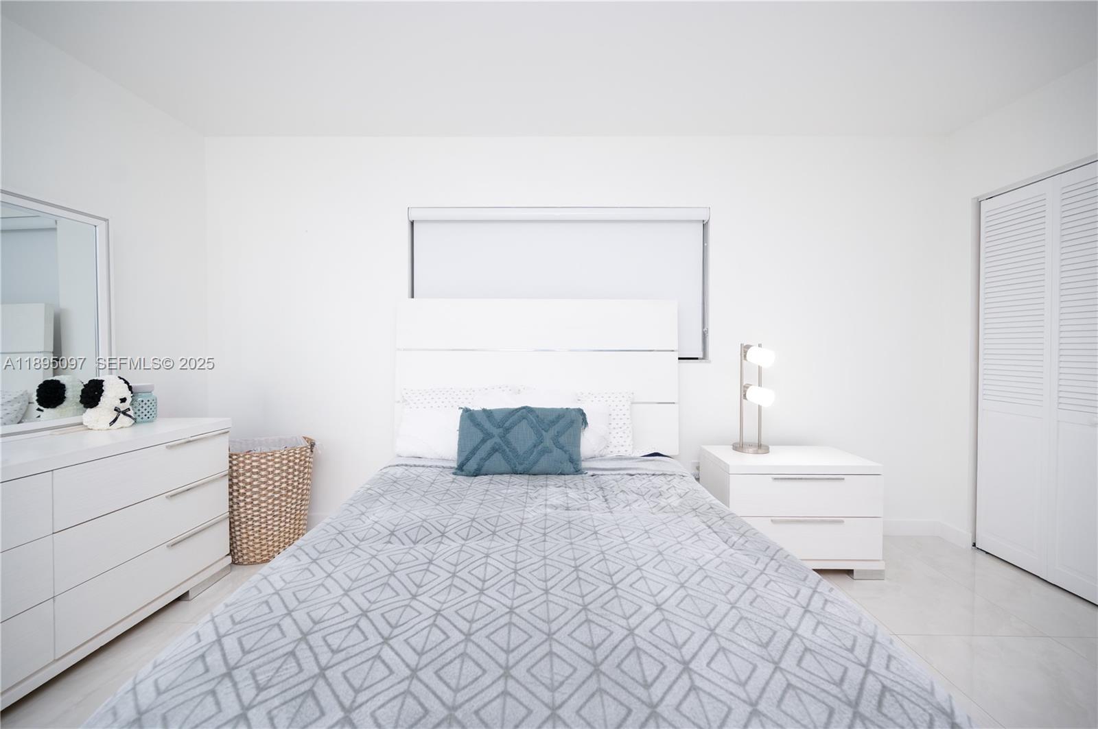 10875 Southwest 112th Avenue, Unit 204 Miami, FL 33176 - Photo 17 of 27 a bedroom with a bed and a window