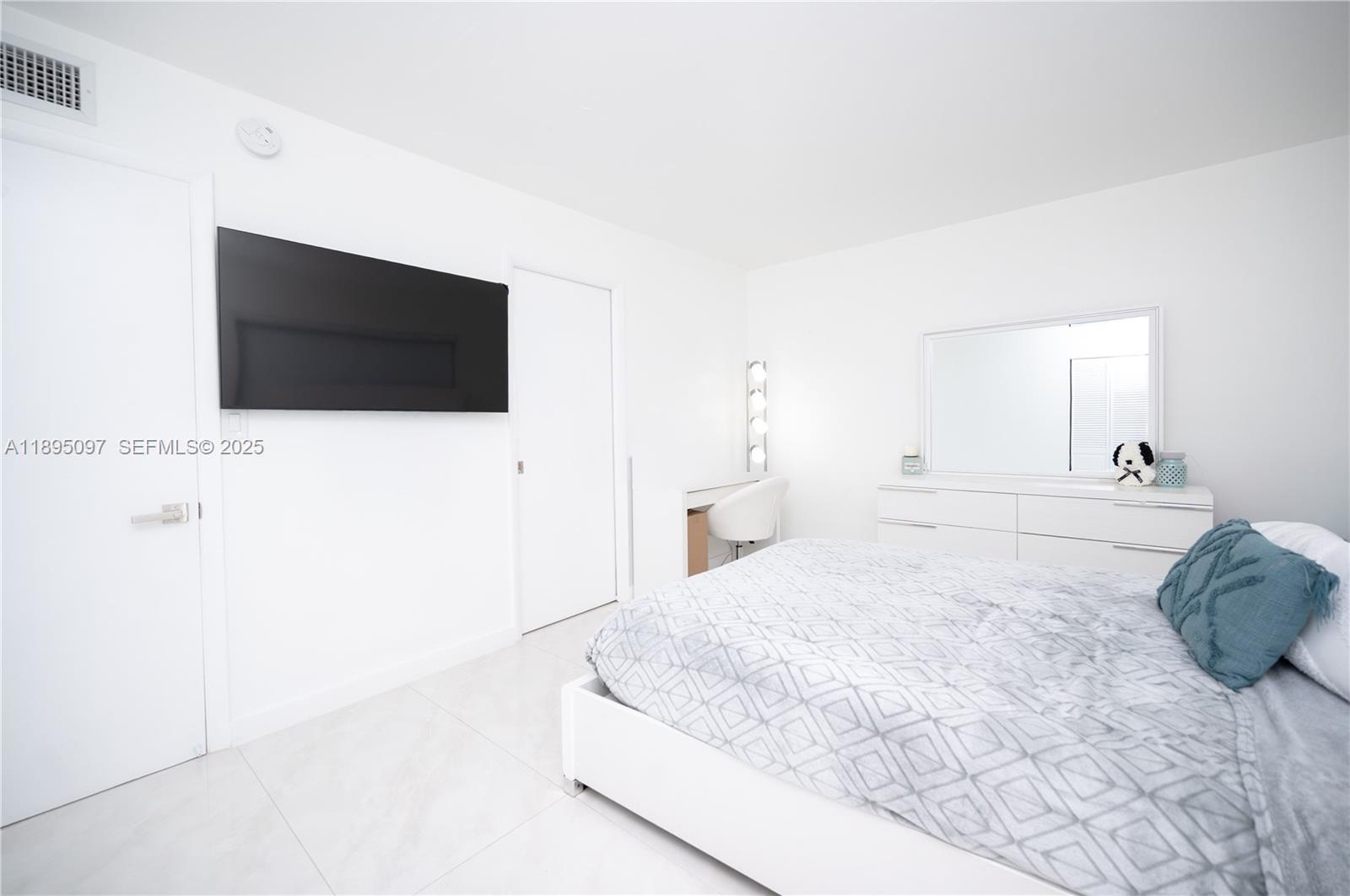 10875 Southwest 112th Avenue, Unit 204 Miami, FL 33176 - Photo 20 of 27 a spacious bedroom with a bed and a flat screen tv