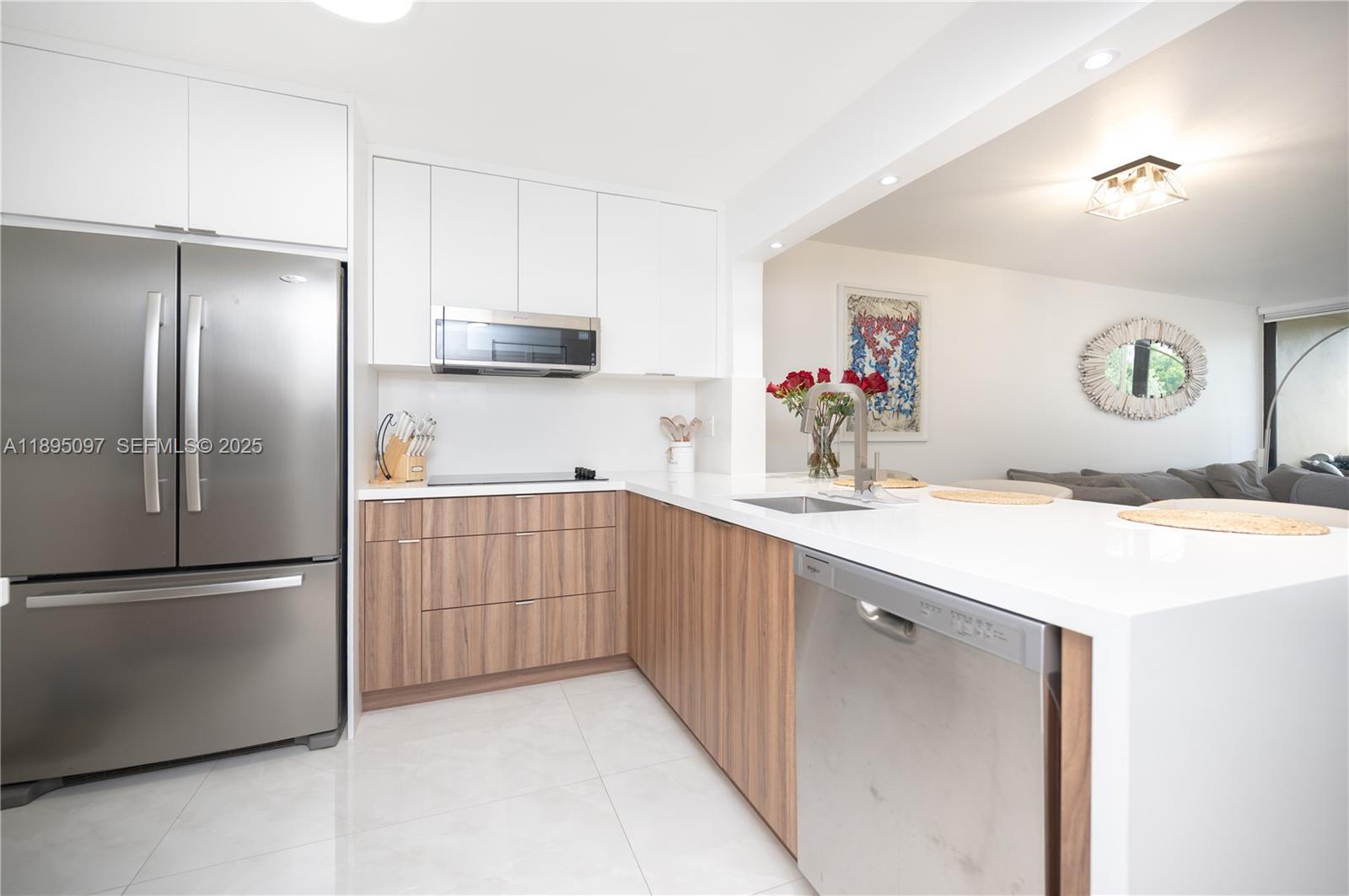 10875 Southwest 112th Avenue, Unit 204 Miami, FL 33176 - Photo 2 of 27 a kitchen with a refrigerator and a sink