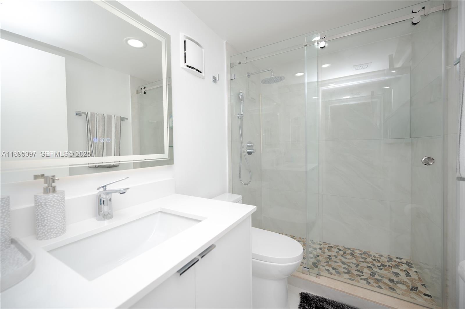 10875 Southwest 112th Avenue, Unit 204 Miami, FL 33176 - Photo 21 of 27 a bathroom with a sink a toilet and shower