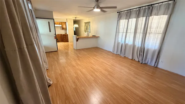 a view of a room with wooden floor and staircase
