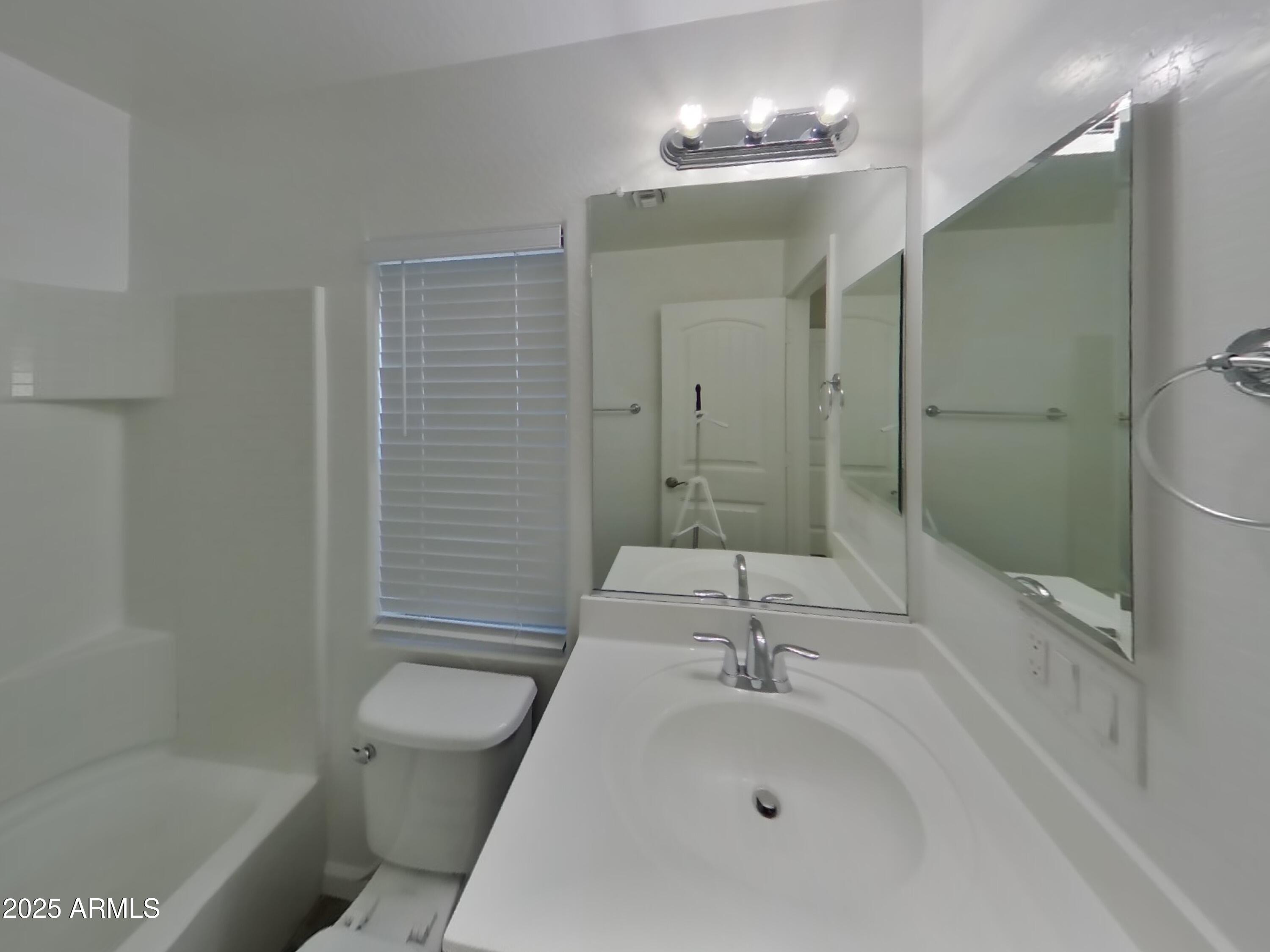 10336 West Devonshire Avenue Phoenix, AZ 85037 - Photo 12 of 18 a bathroom with a sink a toilet and shower