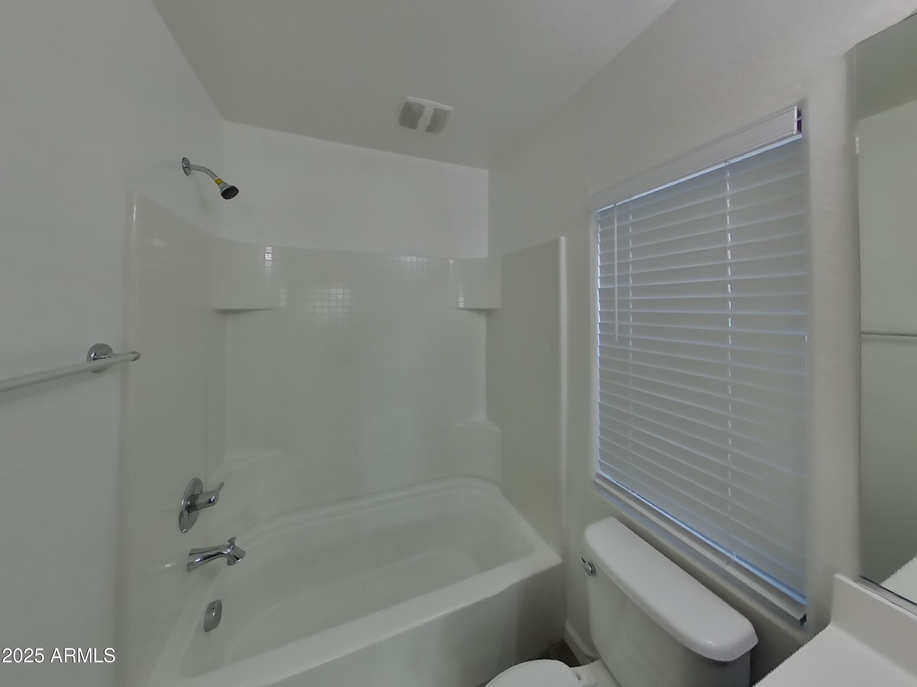 10336 West Devonshire Avenue Phoenix, AZ 85037 - Photo 13 of 18 a bathroom with a bathtub and toilet