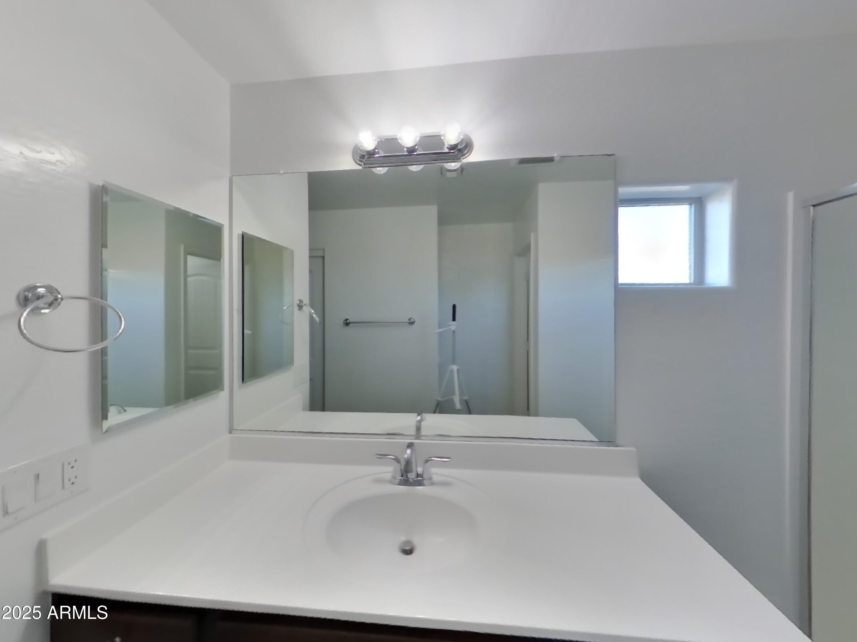 10336 West Devonshire Avenue Phoenix, AZ 85037 - Photo 15 of 18 a bathroom with a sink and a mirror