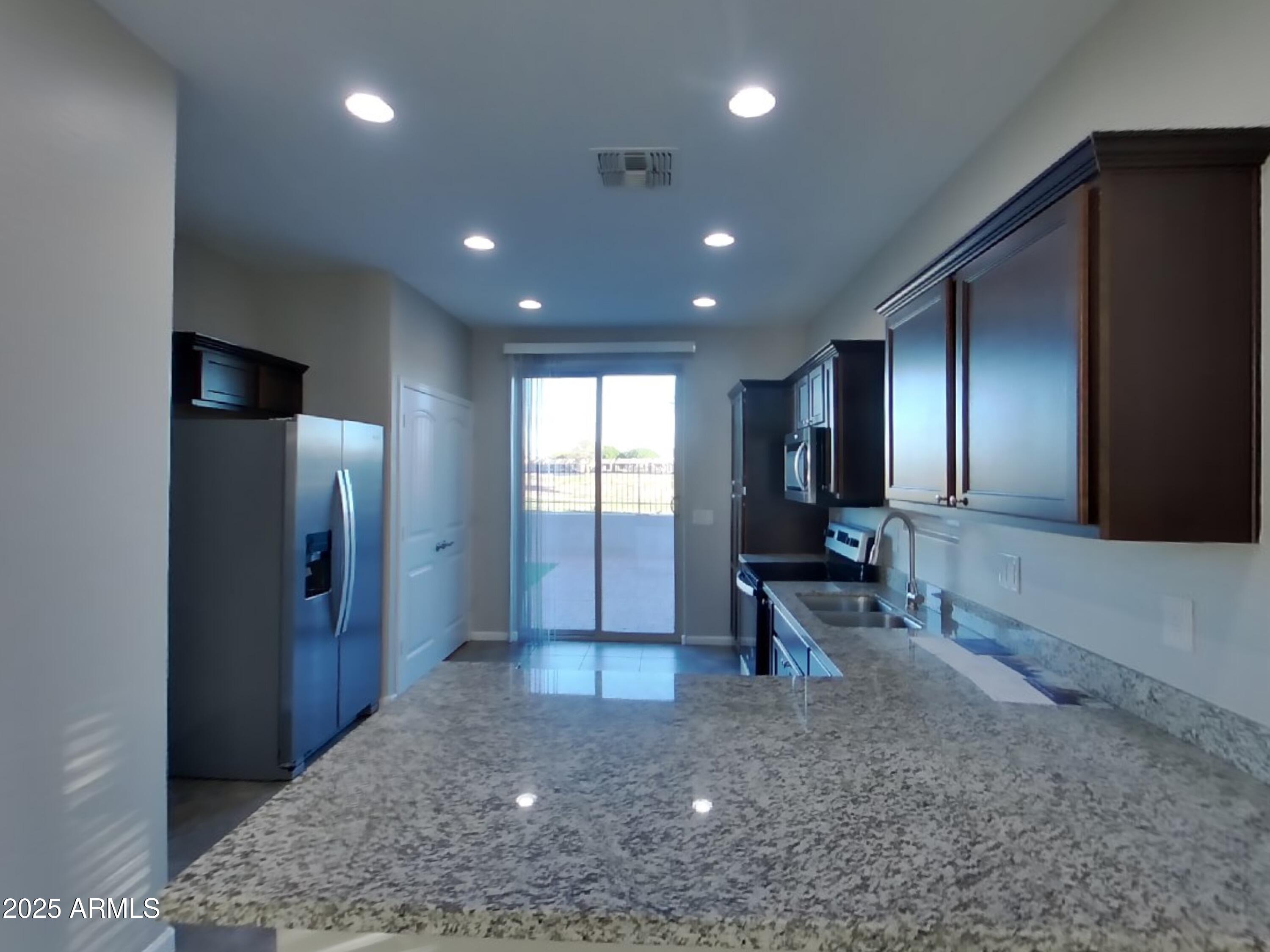 10336 West Devonshire Avenue Phoenix, AZ 85037 - Photo 4 of 18 a view of a hallway with wooden floor and furniture