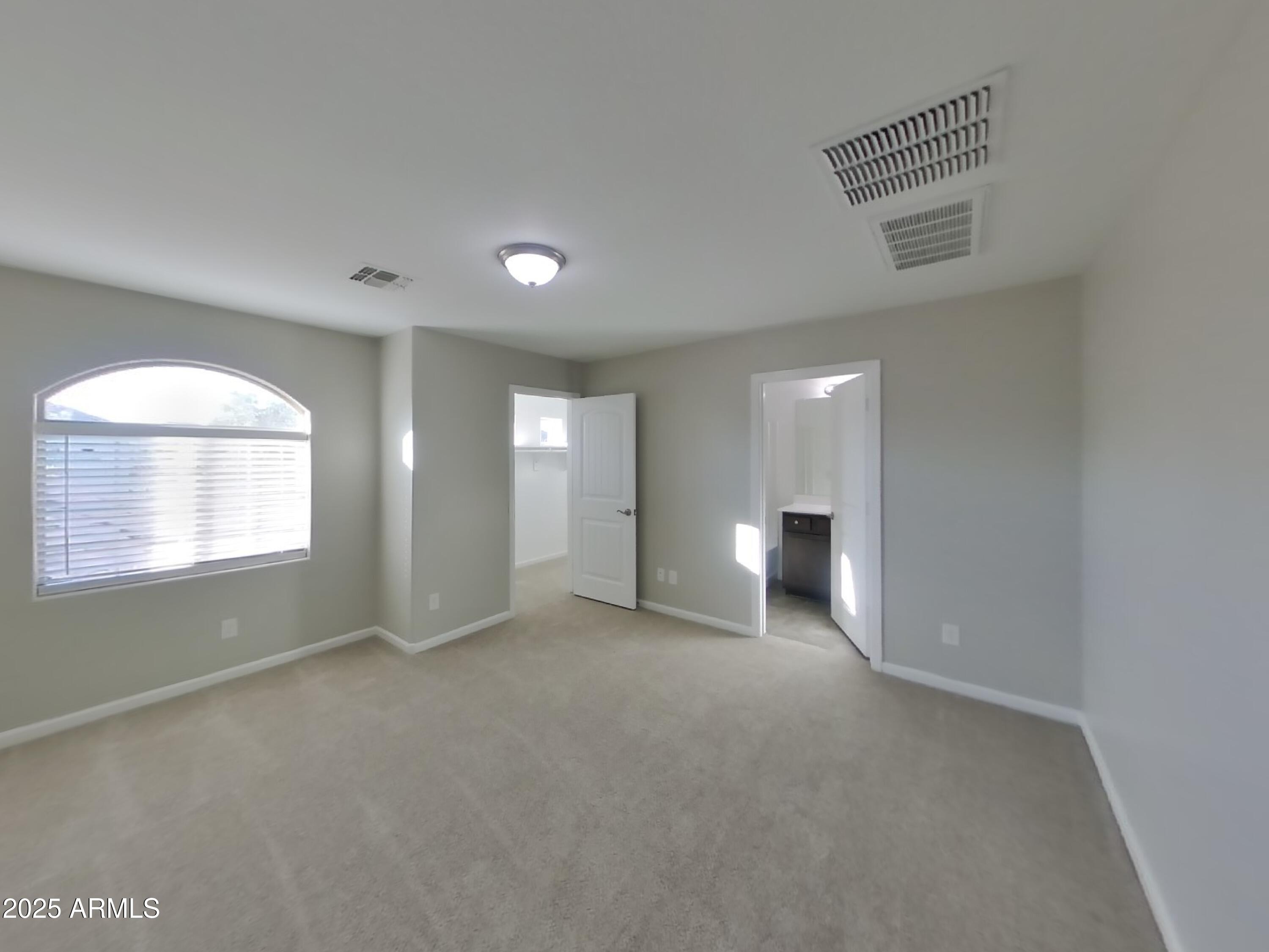 10336 West Devonshire Avenue Phoenix, AZ 85037 - Photo 6 of 18 an empty room with windows and fireplace