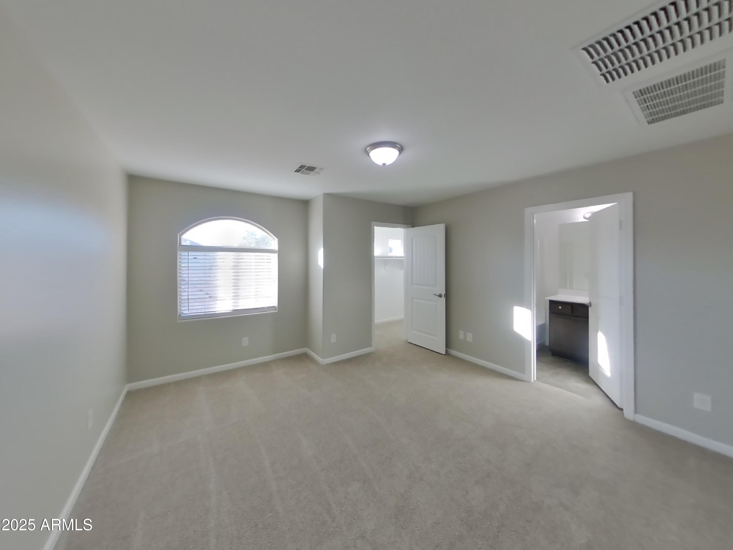 10336 West Devonshire Avenue Phoenix, AZ 85037 - Photo 7 of 18 an empty room with windows