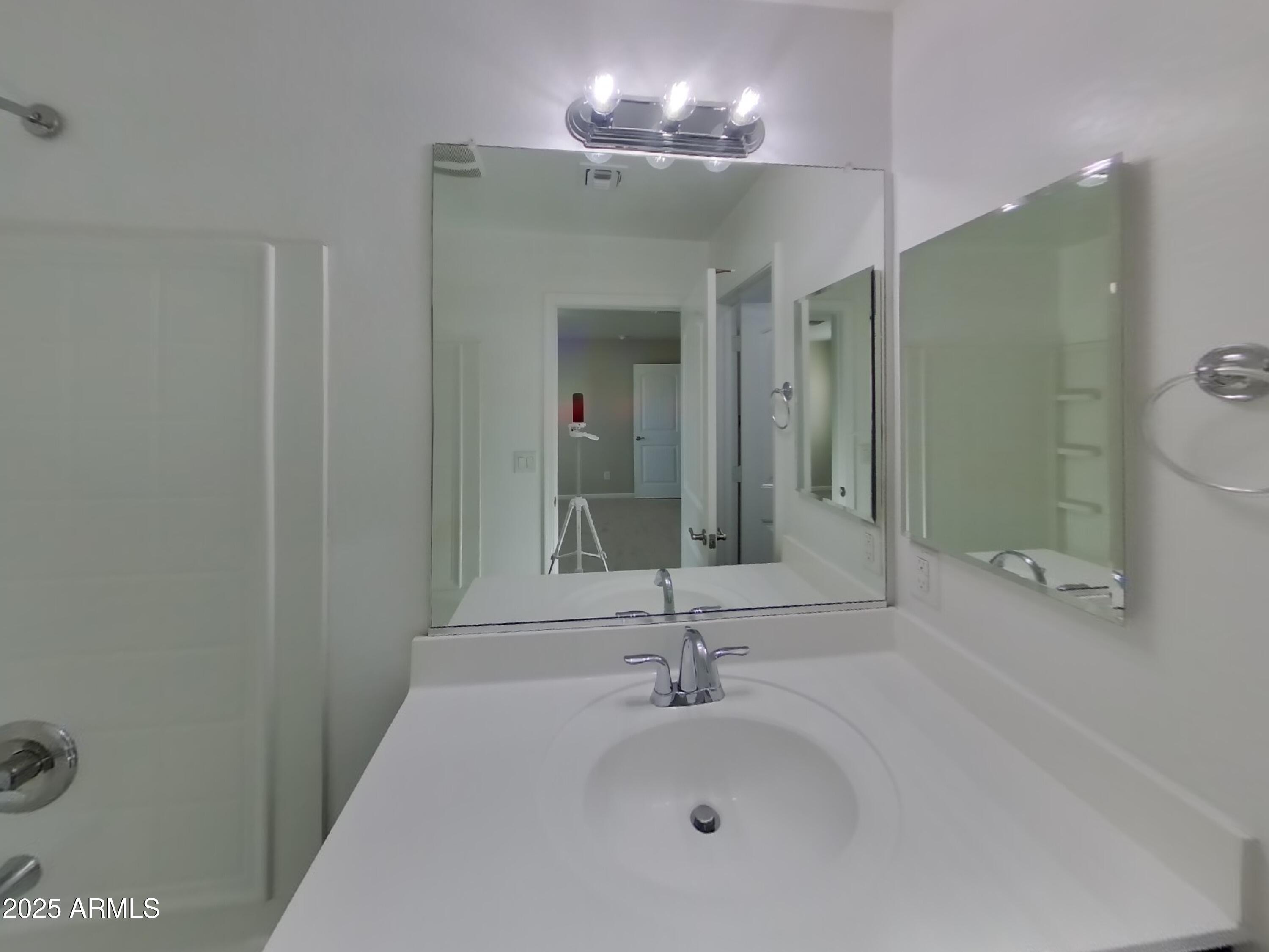 10336 West Devonshire Avenue Phoenix, AZ 85037 - Photo 8 of 18 a bathroom with a sink and a mirror