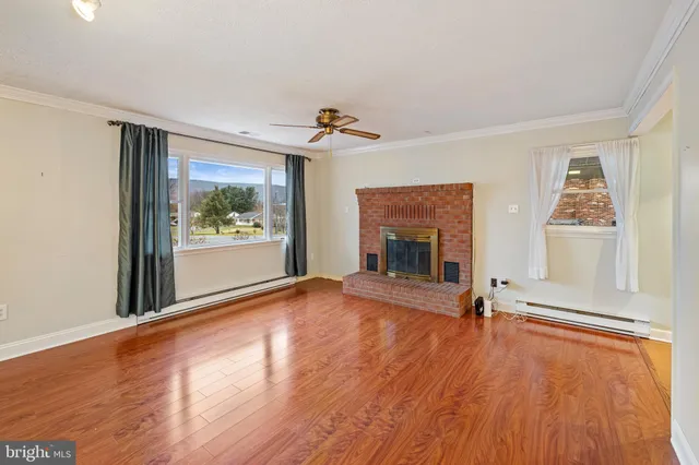 a living room with furniture a rug and a window