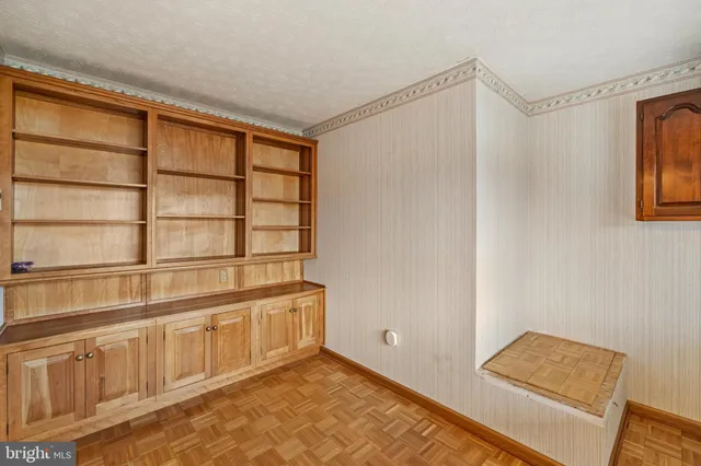 a kitchen with granite countertop wooden cabinets a sink and dishwasher