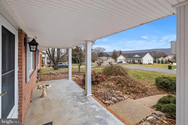 a view of a house with a yard and pathway