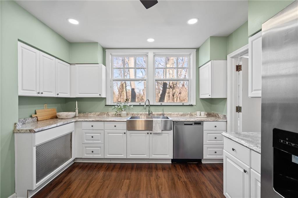 115 Woodland Road Pittsburgh, PA 15232 - Photo 17 of 50 a kitchen with stainless steel appliances granite countertop cabinets wooden floors and white cabinets