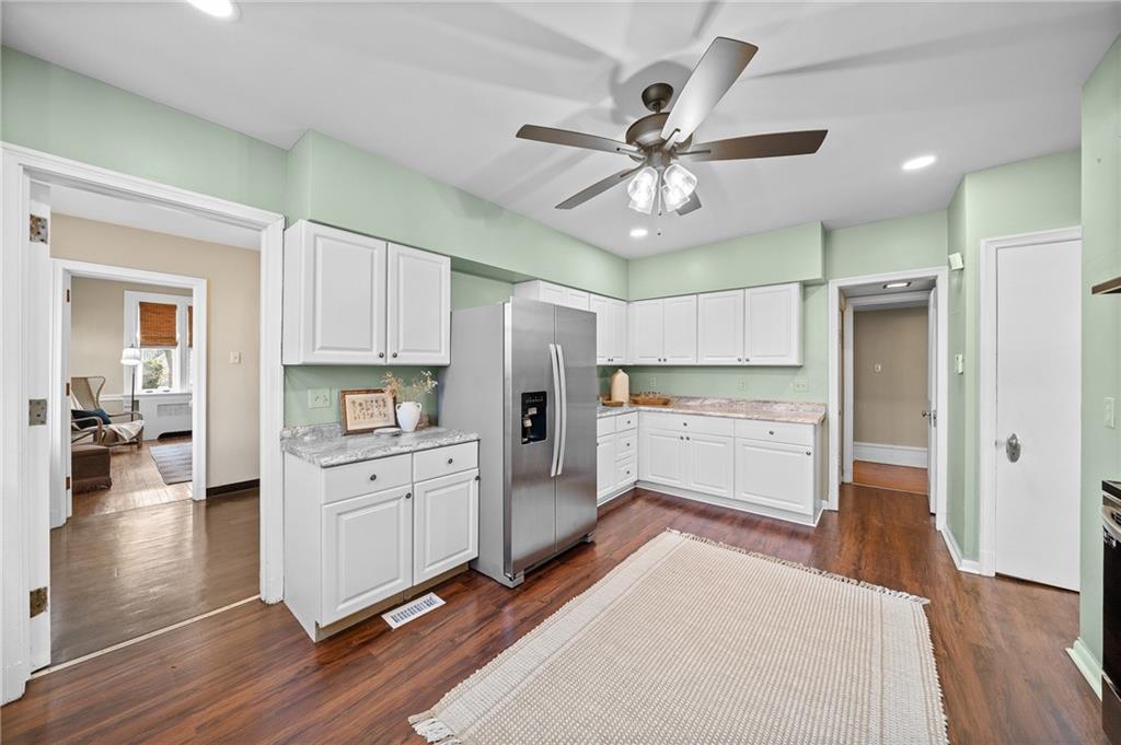 115 Woodland Road Pittsburgh, PA 15232 - Photo 19 of 50 a open kitchen with white cabinets and stainless steel appliances