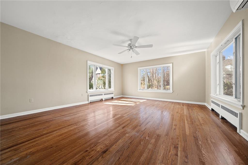 115 Woodland Road Pittsburgh, PA 15232 - Photo 32 of 50 a view of an empty room with wooden floor and window