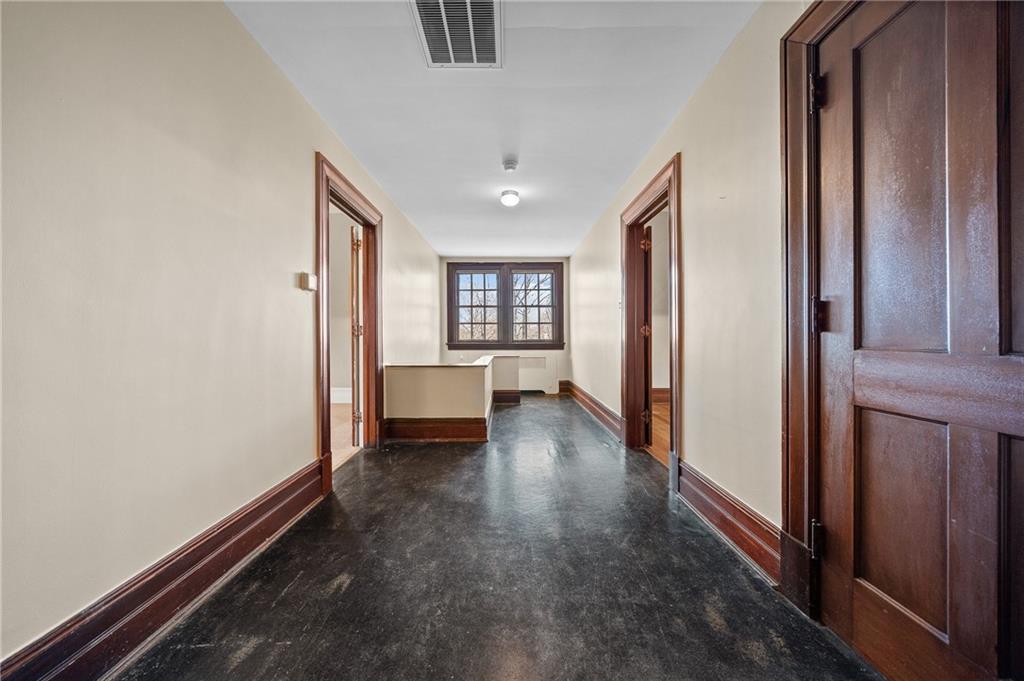 115 Woodland Road Pittsburgh, PA 15232 - Photo 41 of 50 a view of a hallway with wooden floor and furniture
