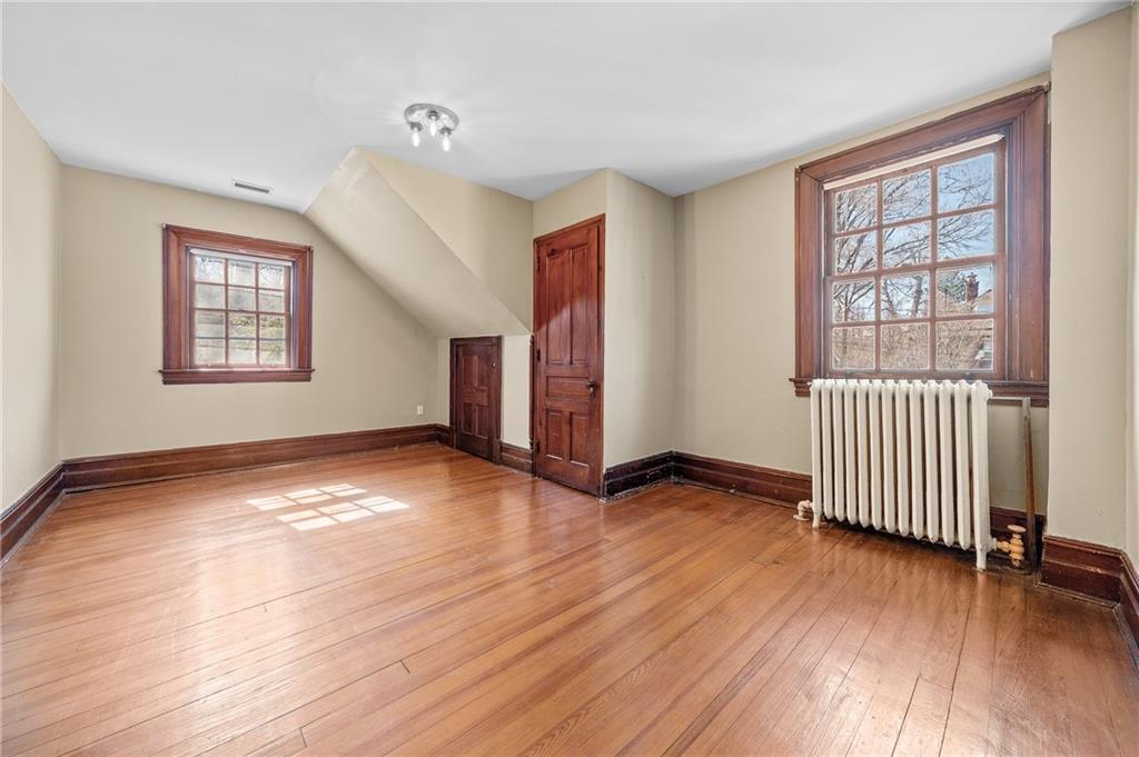 115 Woodland Road Pittsburgh, PA 15232 - Photo 46 of 50 an empty room with wooden floor and windows