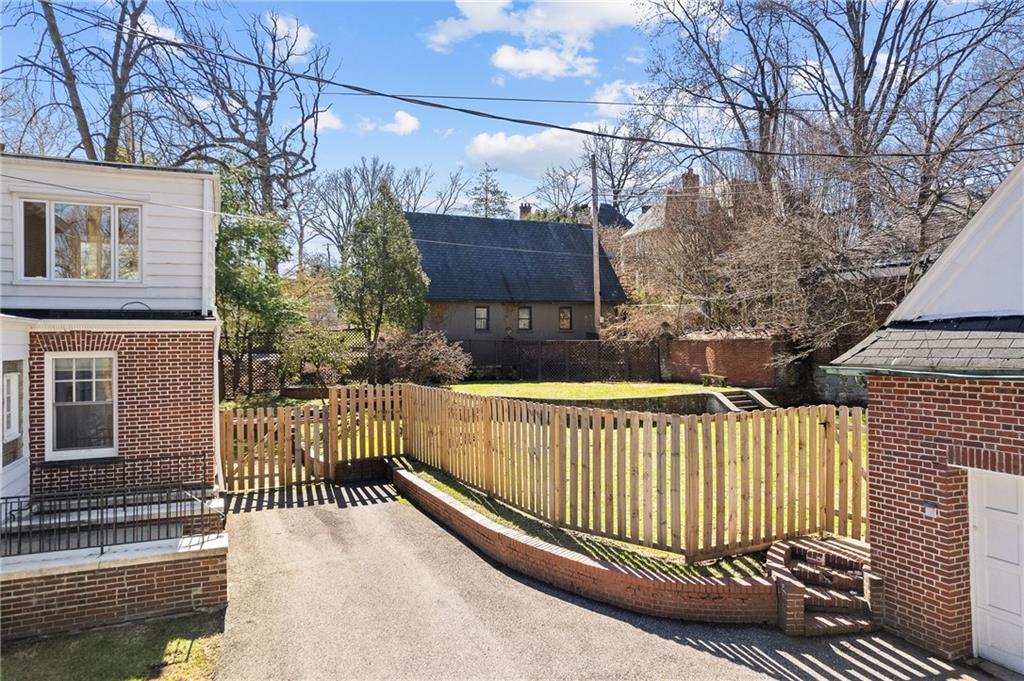 115 Woodland Road Pittsburgh, PA 15232 - Photo 49 of 50 a view of a house with a wooden fence