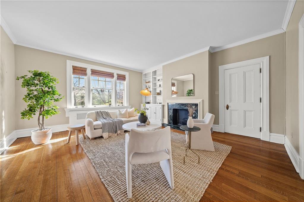 115 Woodland Road Pittsburgh, PA 15232 - Photo 6 of 50 a living room with furniture a fireplace and a table