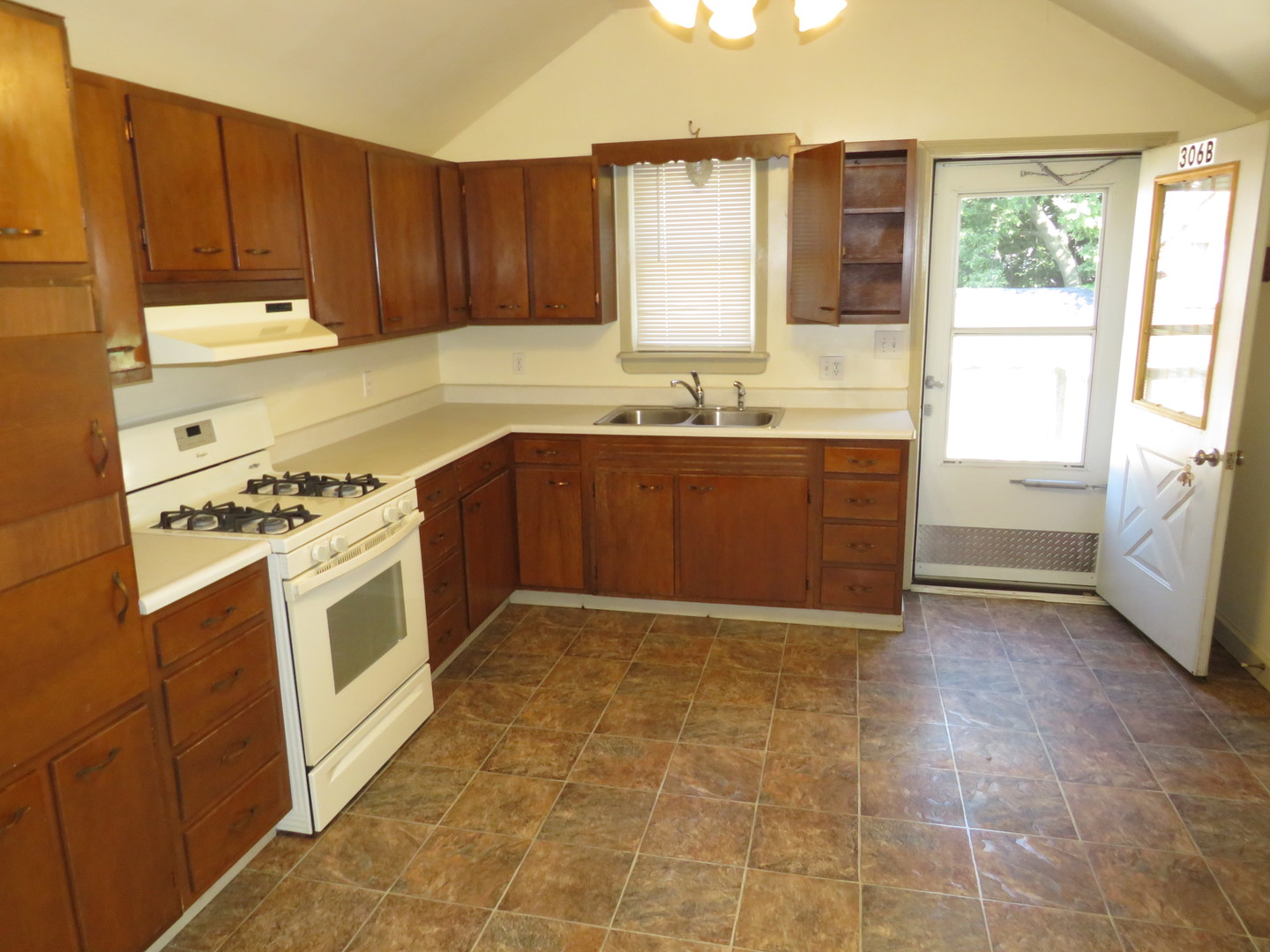 306 East Main Street, Unit B Ottawa, IL 61350 - Photo 10 of 15 a kitchen with a stove a sink and a refrigerator