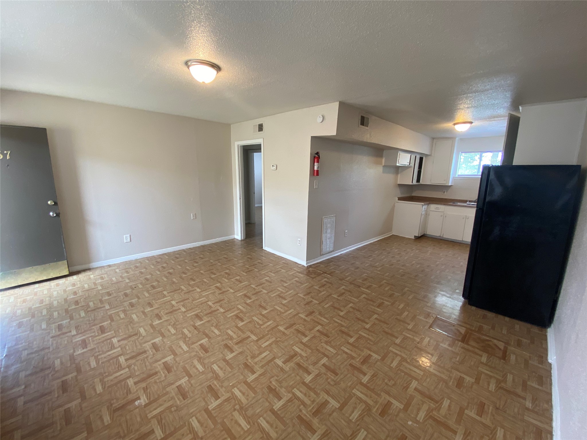 5610 Royal Palms Street, Unit 67 Houston, TX 77021 - Photo 4 of 11 a view of a refrigerator in kitchen and an empty room
