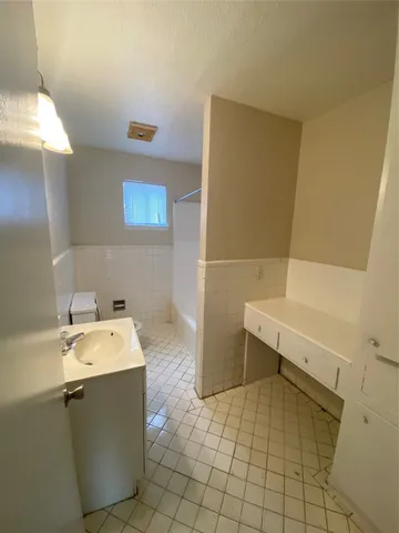 a bathroom with a sink toilet and tub