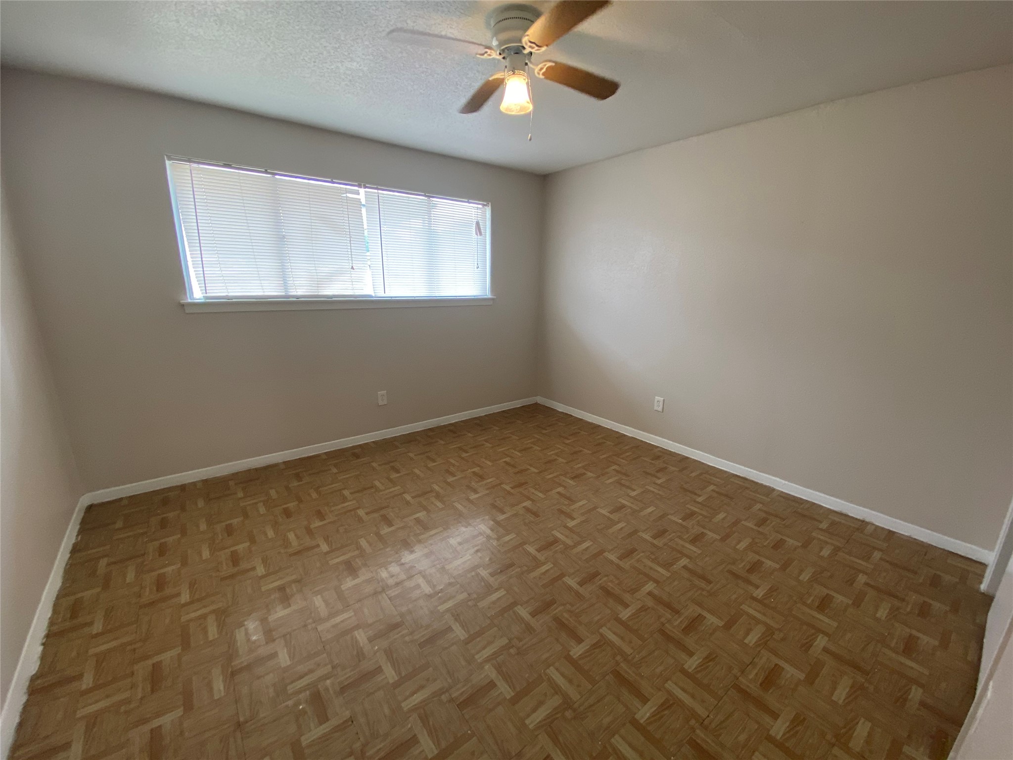 5610 Royal Palms Street, Unit 67 Houston, TX 77021 - Photo 8 of 11 an empty room with a chandelier fan and windows