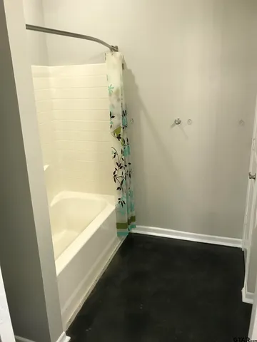 a bathroom with a bathtub and shower