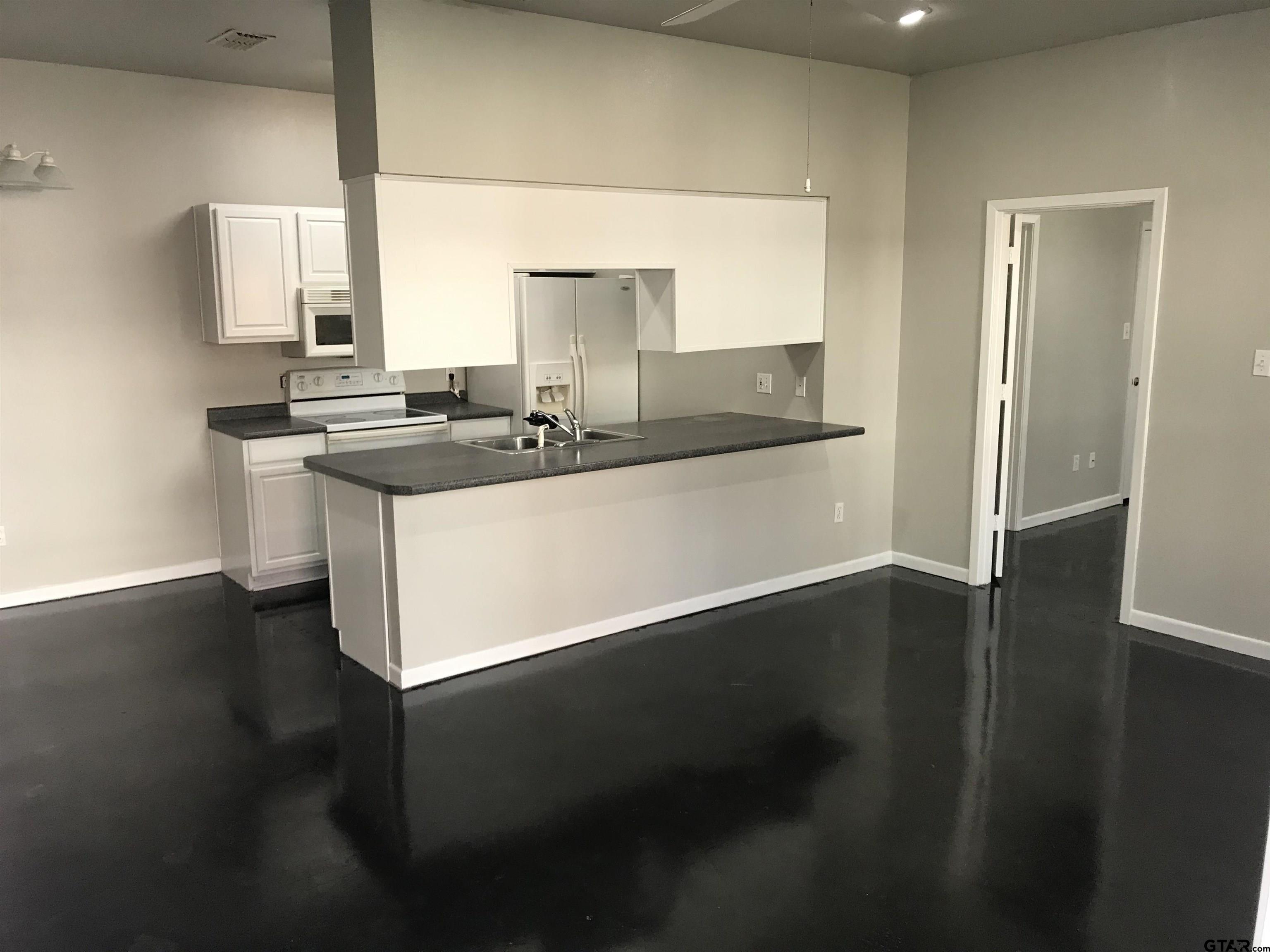 19040 FM 2493 Flint, TX 75762 - Photo 4 of 18 a kitchen with stainless steel appliances a sink stove and wooden floor
