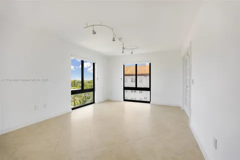 an empty room with windows and closet