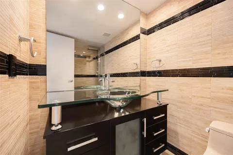 a bathroom with a sink a toilet and a shower