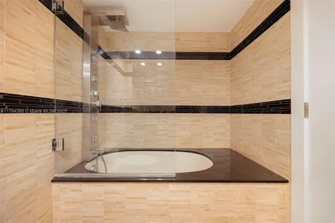 a bathroom with a sink a mirror and shower