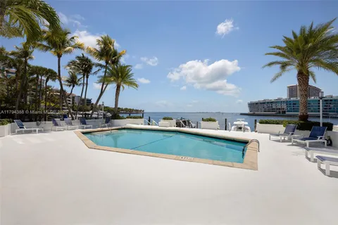 a view of a swimming pool with a table and chairs