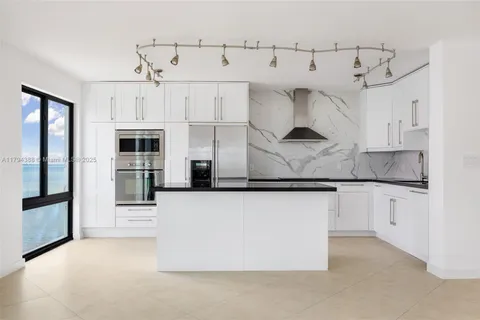 a kitchen with stainless steel appliances granite countertop a stove and a refrigerator